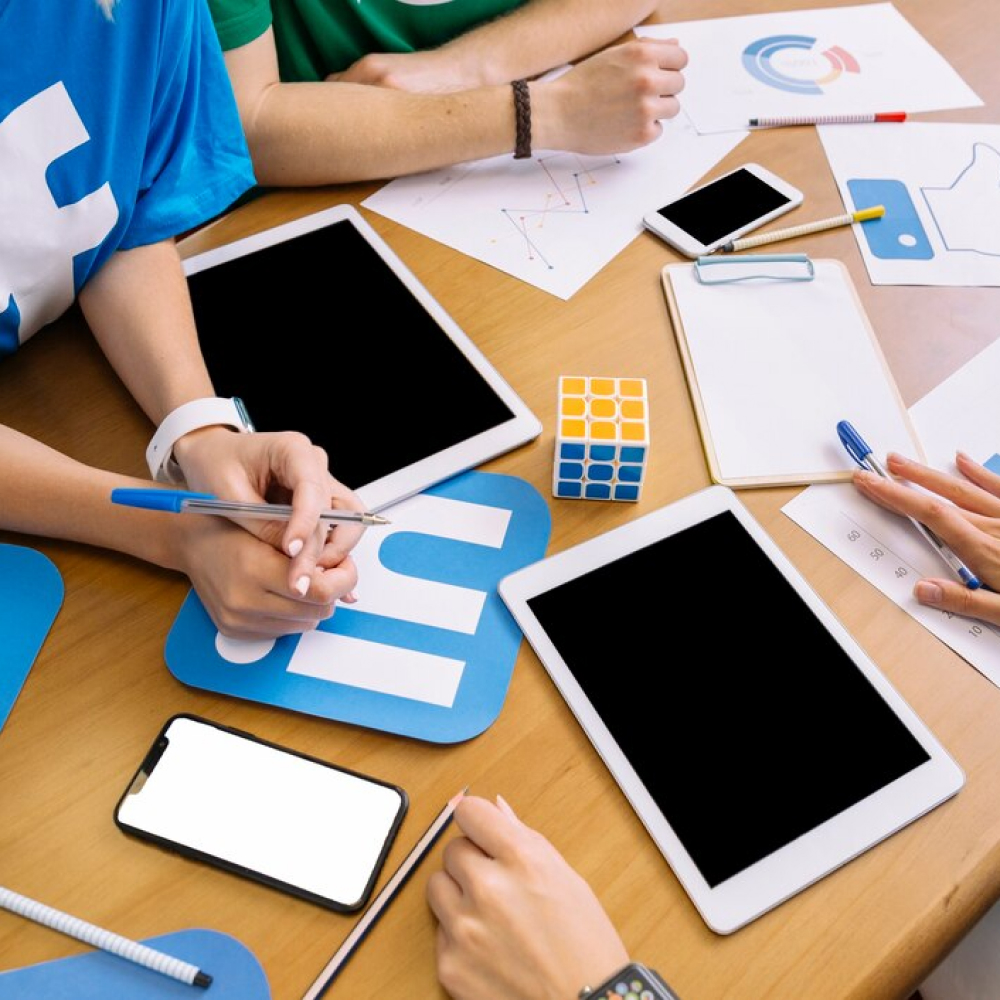 close-up-businesspeople-with-digital-tablet-social-media-icons-table_23-2147847546 (1)