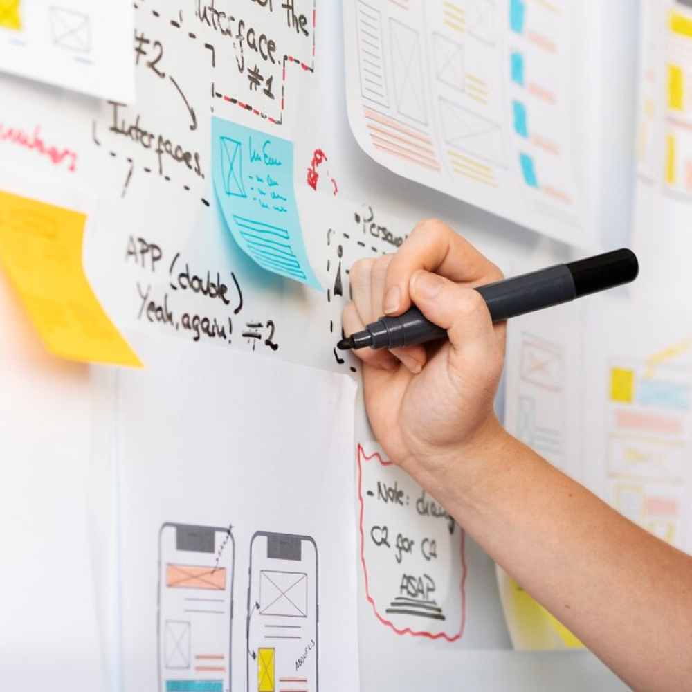 female-web-designer-with-papers-notes-office_23-2149749914 (1)